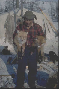 Sam Napeo with two frozen foxes taken in a trap at Ashuapun. Photo courtesy Georg Henriksen.