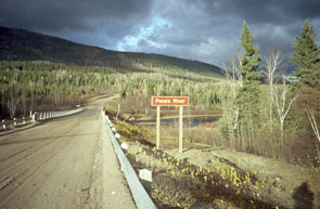 Uapushkakamau-shipu. The cross marking the place where the late Munik Pone's ashes were placed in the river is by the bridge on the opposite side of the river. Photo courtesy Peter Armitage.