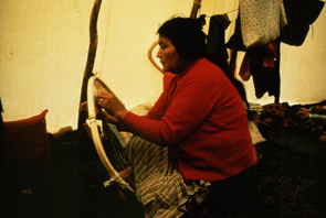 Nishet Penashue lacing snowshoes in her tent at Enakapeshakamau. Photo Nigel Markham, courtesy Innu Nation.