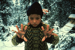 Shuash Nuna playing cat's cradle at his camp at Enakapeshakamau. Photo Nigel Markham, courtesy Innu Nation.