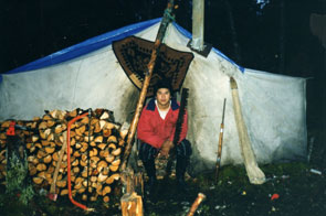 Edmund Benuen in front of his tent at the Mishtashini camp, archaeological survey. Photo courtesy Fred Schwarz.